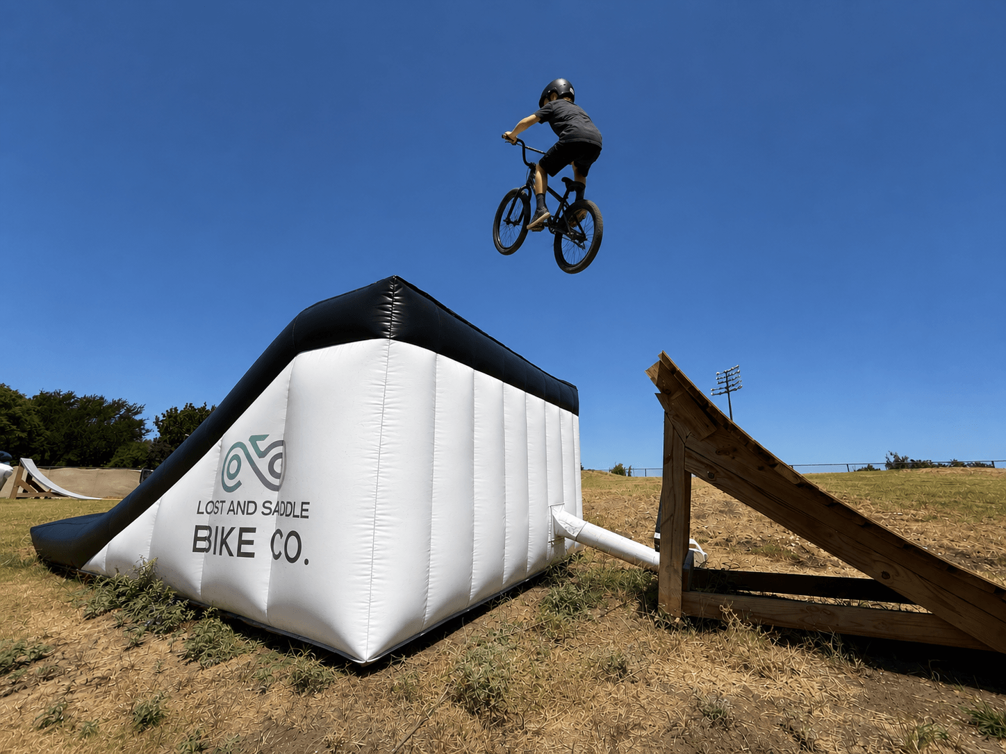 BMX rider jumping into the air bag course at Alliance Skatepark in Grand Prairie.