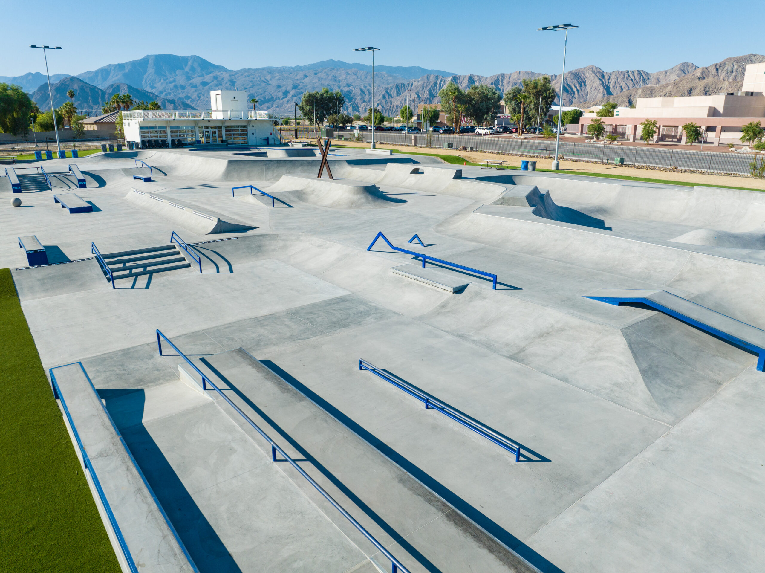 Bowls, rails, and the street plaza at La Quinta X Park, with mountains behind the facility.